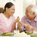 Senior asian couple sharing meal at home